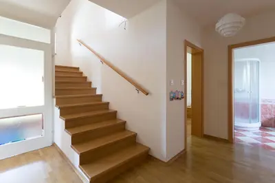 a staircase in a home with a wooden floor at Vacation Home Sofia in Zgornje Gorje