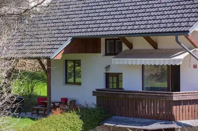 a house with a porch and a deck at Vacation Home Sofia in Zgornje Gorje