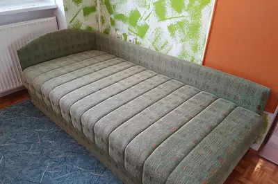 a couch sitting in a corner of a room at Apartmaji Tisa in Moravske Toplice