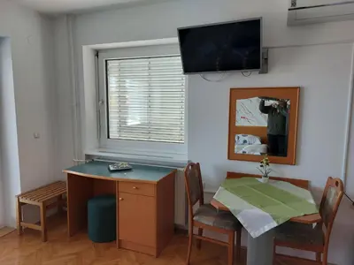 a room with a desk and a table with a mirror at Apartmaji Tisa in Moravske Toplice