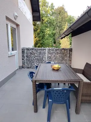 a wooden table and chairs on a patio at Apartment Stella in Dolenjske Toplice