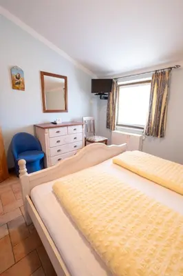 a bedroom with two beds and a dresser and a window at Farm Stay Malovščevo in Vitovlje