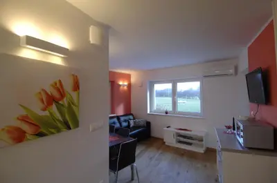 a living room with a couch and a window at Apartments & Wellness Skok in Mozirje