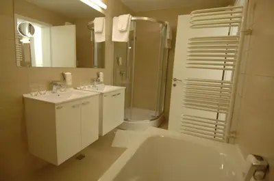 a bathroom with a tub and a sink and a shower at Apartments & Wellness Skok in Mozirje