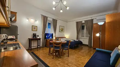 a living room with a kitchen and a dining room at Spacious central studio Nika 2 Tour As Ljubljana in Ljubljana