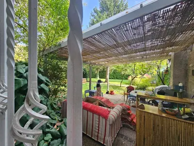 a patio with a couch under a pergola at Spacious central studio Nika 2 Tour As Ljubljana in Ljubljana