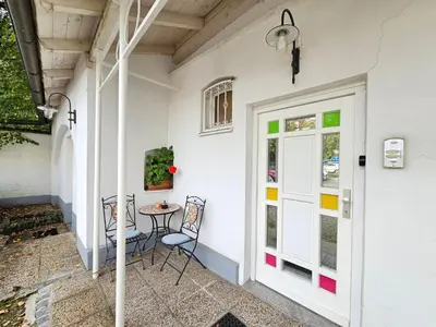 a patio with a table and chairs next to a door at Spacious central studio Nika 2 Tour As Ljubljana in Ljubljana