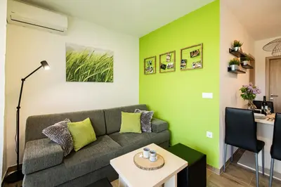 a living room with a couch and a table at Apartmaji BANONIA 