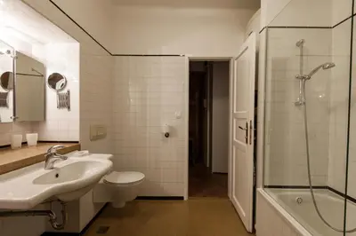 a bathroom with a sink and a toilet and a shower at River and Castle View Apartment Rose Tour As Ljubljana in Ljubljana