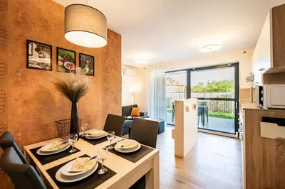 a dining room and kitchen with a table and chairs at Apartmaji BANONIA 