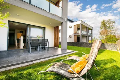 a yard with a chair and a house at Apartmaji BANONIA 