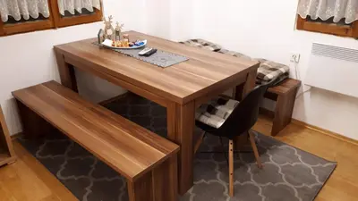 a wooden table and a chair in a room at KRESNIČKA in Čatež ob Savi