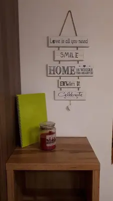 a table with a jar of jam and a sign on a wall at KRESNIČKA in Čatež ob Savi