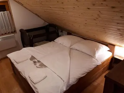 a bed with white sheets and pillows in a room at KRESNIČKA in Čatež ob Savi