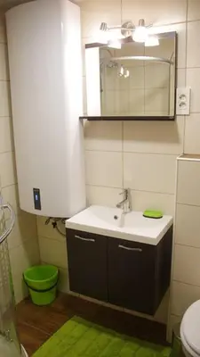 a bathroom with a sink and a toilet and a mirror at KRESNIČKA in Čatež ob Savi