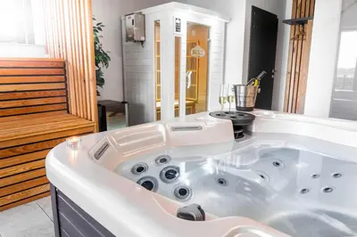 a large white bath tub in a bathroom at Apartments Sunrise Banovci in Banovci