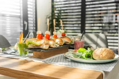 a table topped with plates of food and sandwiches at Apartments Sunrise Banovci in Banovci