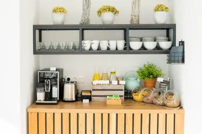 a counter with a coffee maker on top of it at Apartments Sunrise Banovci in Banovci