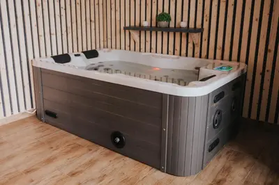 a jacuzzi tub in the corner of a room at Apartments Sunrise Banovci in Banovci