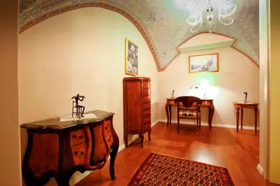 a living room with a table and a dining room at Hotel Actum in Kranj