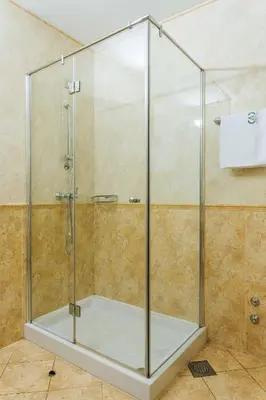 a shower with a glass enclosure in a bathroom at Hotel Actum in Kranj