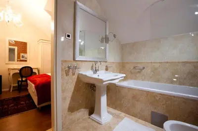 a bathroom with a sink and a bath tub at Hotel Actum in Kranj