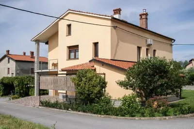 a house on the side of a street at Borea Rooms - Sobe Budanje in Vipava