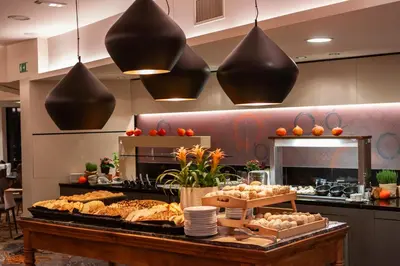 a buffet line with bread and pastries on a table at Hotel Vitarium Superior - Terme Krka in Smarjeske Toplice