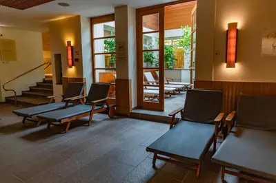 a waiting room with chairs and stairs in a building at Hotel Vitarium Superior - Terme Krka in Smarjeske Toplice