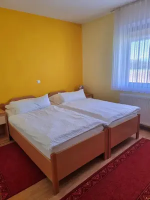 a large bed in a bedroom with a yellow wall at Bed and Breakfast Valjavec in Kranj