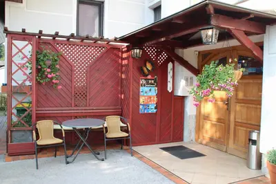 a patio with a table and chairs in front of a building at Bed and Breakfast Valjavec in Kranj