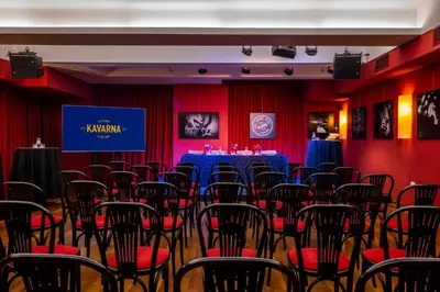 a conference room with red walls and a table with red chairs at Hotel Slamič Ljubljana in Ljubljana