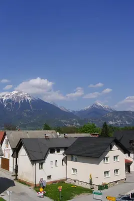 a group of houses with mountains in the background at Apartmaji Pri Kokolu in Bled