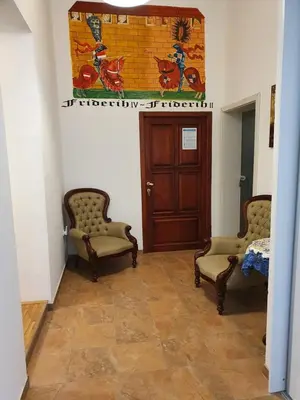 a hallway with two chairs and a door at Apartments Fazarinc with parking, wellness and city store in the center of Celje in Celje