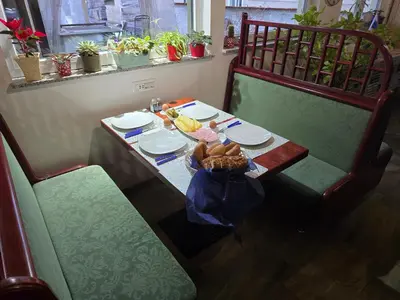 a table with plates and a basket of food on it at Apartments Fazarinc with parking, wellness and city store in the center of Celje in Celje