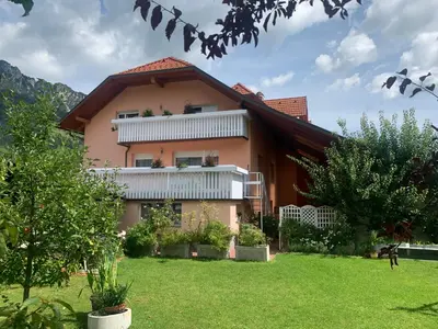 a large house with a lawn in front of it at Apartma Metka in Mojstrana