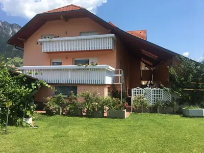 a house with a lawn in front of it at Apartma Metka in Mojstrana