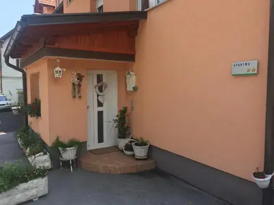 a front door of a building with potted plants at Apartma Metka in Mojstrana