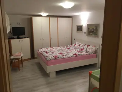 a bedroom with a bed and a tv in it at Apartma Metka in Mojstrana