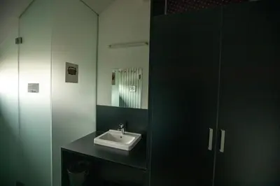 a bathroom with a sink and a mirror at MCC Hostel in Celje