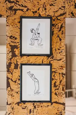 two framed drawings of a man on a wall at Chaplin Apartment - Free Garage Parking in Ljubljana
