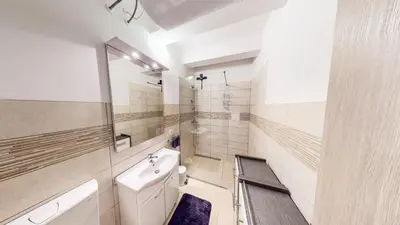 a white bathroom with a sink and a toilet at Chaplin Apartment - Free Garage Parking in Ljubljana