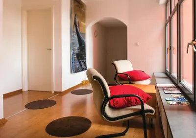 a living room with two chairs and a table at Cukrarna Guest Accommodation in Kranj