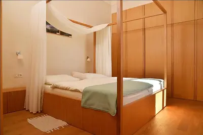 a small bedroom with a bed and a window at Grad Goričko in Grad