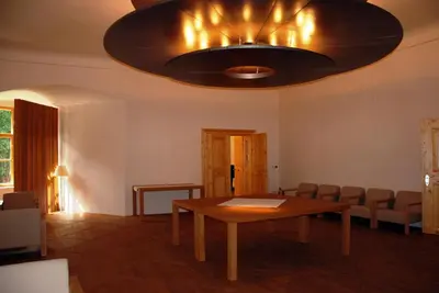 a dining room with a table and a chandelier at Grad Goričko in Grad
