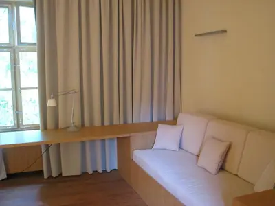 a living room with a white couch and a desk at Grad Goričko in Grad