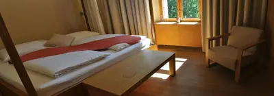 a bedroom with a bed and a chair and a window at Grad Goričko in Grad