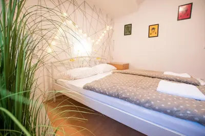 a bedroom with a bed and a plant at The Maze Apartment in Ljubljana