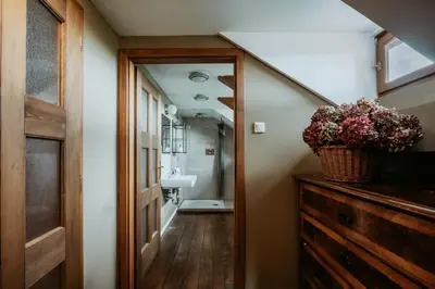 a bathroom with a staircase leading to a bathroom with a sink at Hisa Vina in Podlehnik