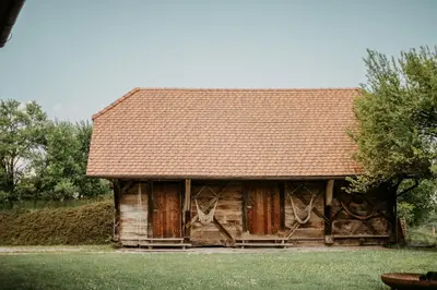 a wooden cabin with a brown roof at Hisa Vina in Podlehnik